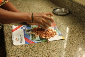 Crush them with a heavy vessel. Here we used a stone garlic pounder. 